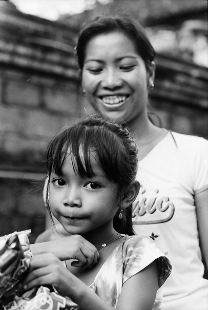 Girl And Her Mother On A Motorbike (Indonesia)