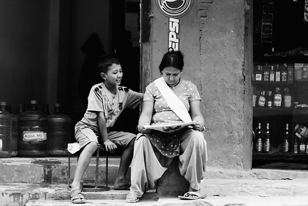 Mother and son reading newspaper