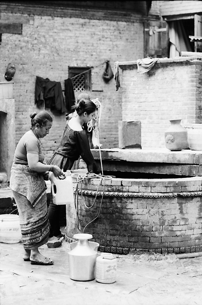 Bhaktapur Nepal Women Drawing Water From A Well Travel Photo Essay It can be obtained by drawing water from a well located at the town square, peteran monastery or from the jacoban cathedral. bhaktapur nepal women drawing water