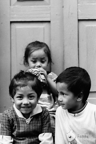 Three Kids Sitting In The Lane (Nepal)