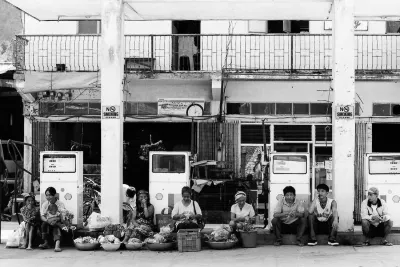 Many hawkers resting under roof in gas station