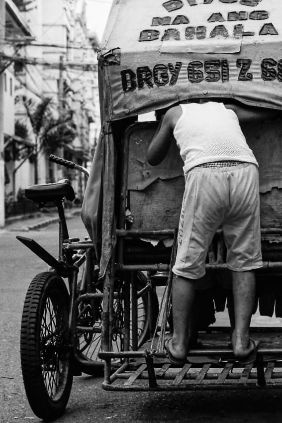Boy peeping inside of tricycle