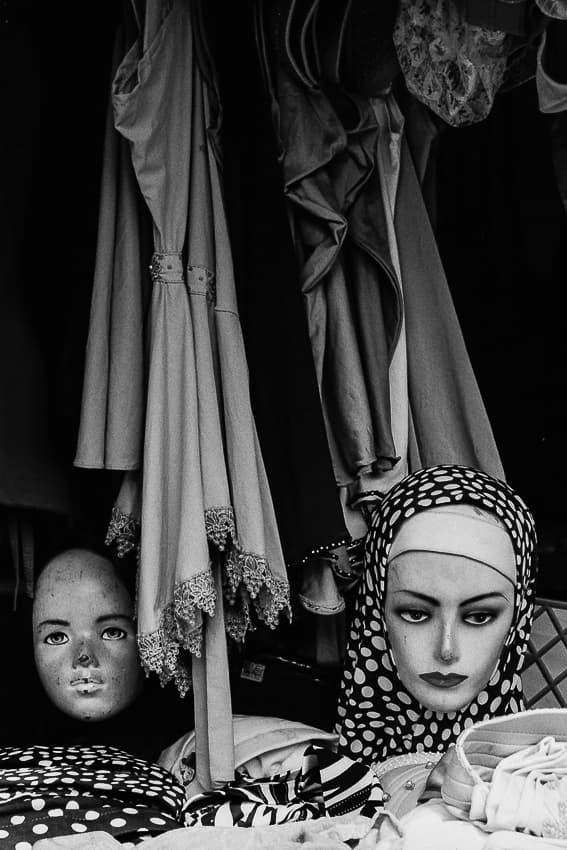 two faces of mannequin in storefront