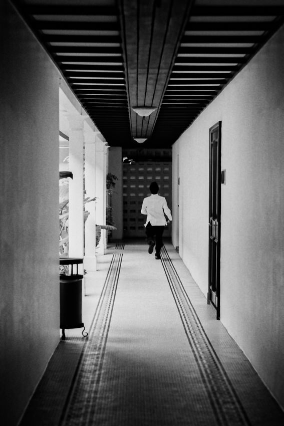 Hotel employee running corridor