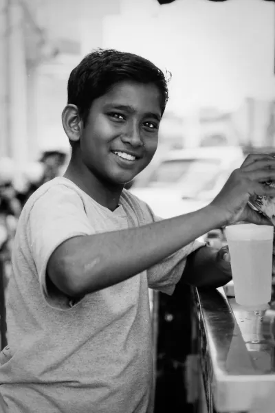 Boy making fresh juice happily