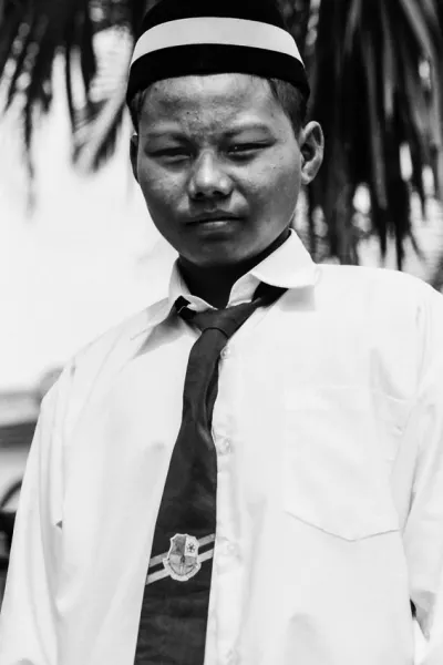 Boy wearing school uniform and songkok