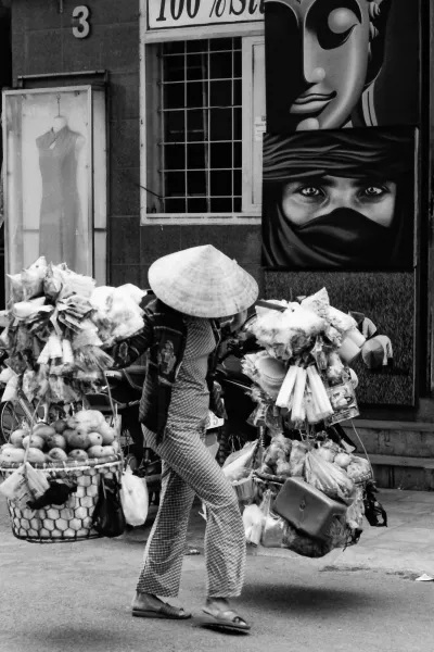 Woman carrying many goods with yoke