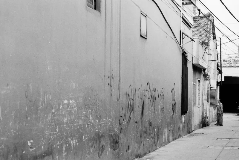 Man standing at end of wall