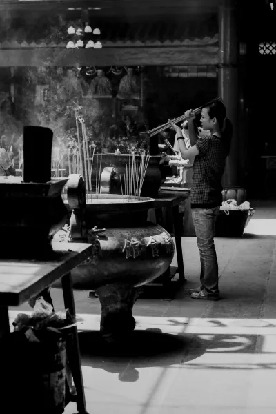 Woman lighting incense sticks on fire