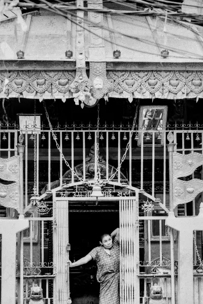 Woman standing at the entrance of Hindu temple