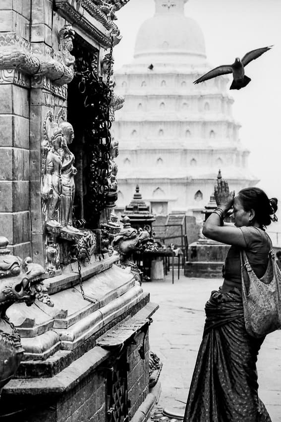 Woman praying in front of altar