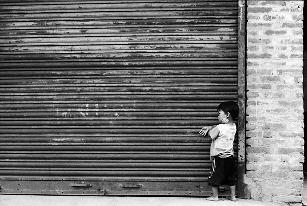 Lonley Boy In Front Of The Shutter (Nepal)