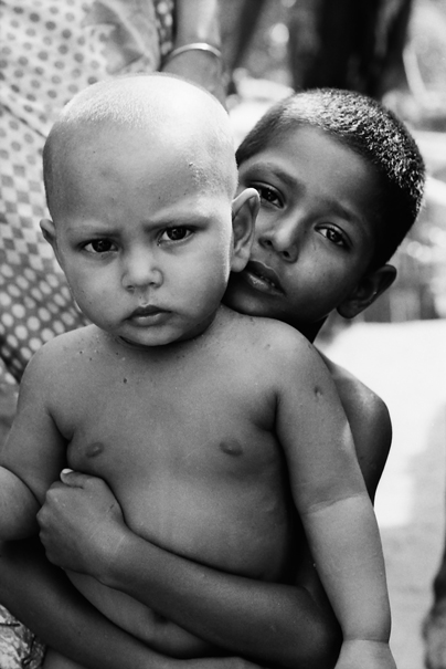 Boy clasping little brother