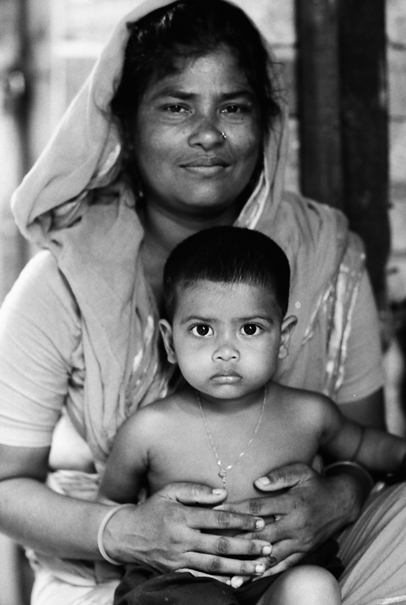 Mother With A Soft Face Holds Her Son (Bangladesh)