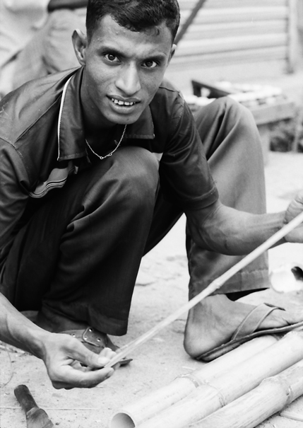 Man taking size of bamboos