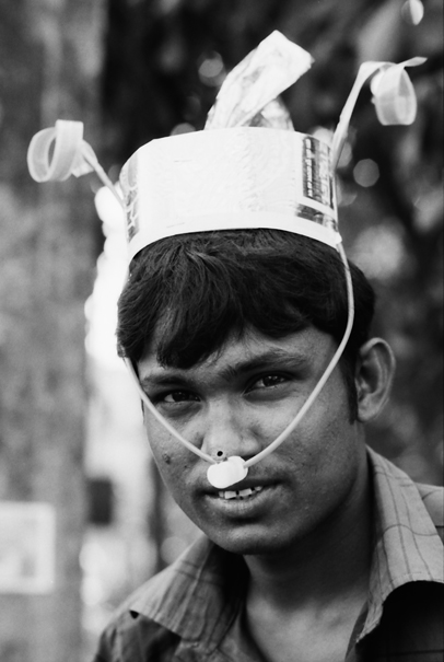 Man wearing cap with party horns