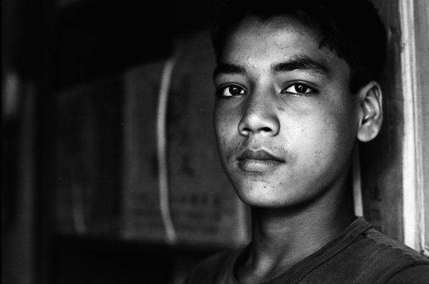 Young man leaning against wall