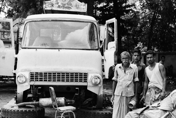 Men standing beside truck