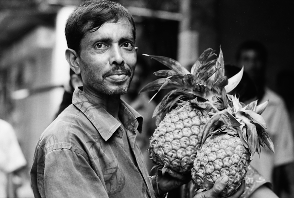 Man having two pineapples