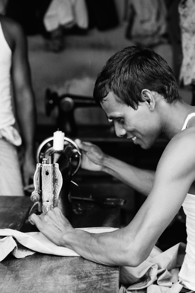 Man manipulating sewing machine