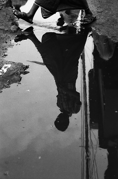 Figure reflected in puddle