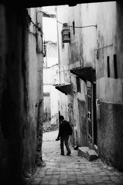 Man Walking The Dim Lane (Morocco)