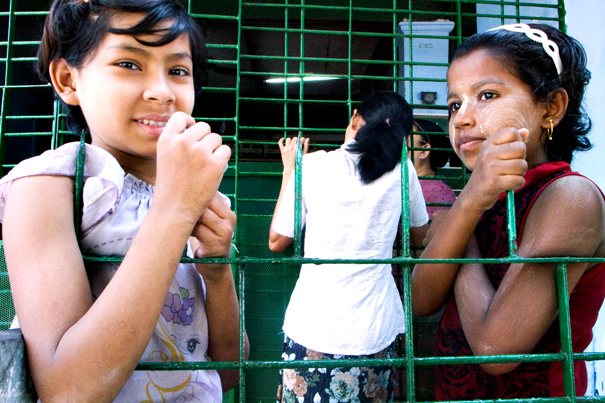 Two Girls At Wire Netting (Myanmar)
