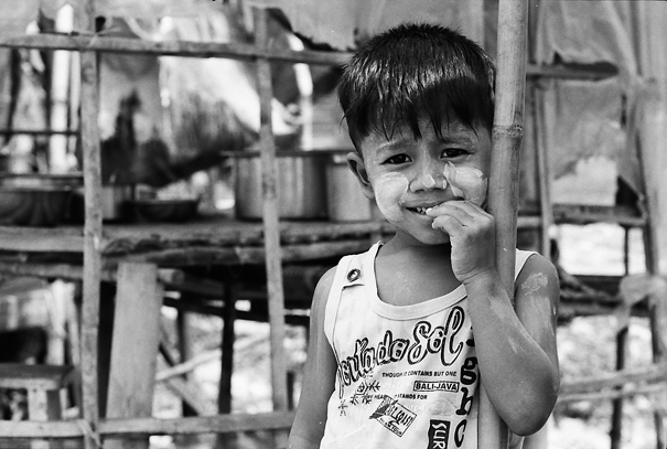 Boy Leaning Against A Bamboo Pillar (Myanmar)