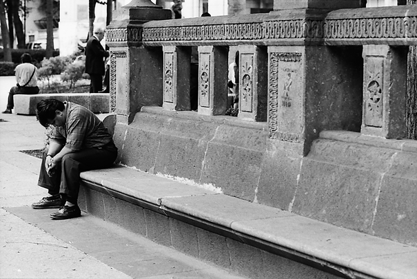 Man looking down on bench