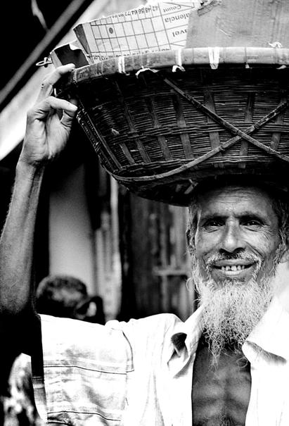 Man carrying with basket on head