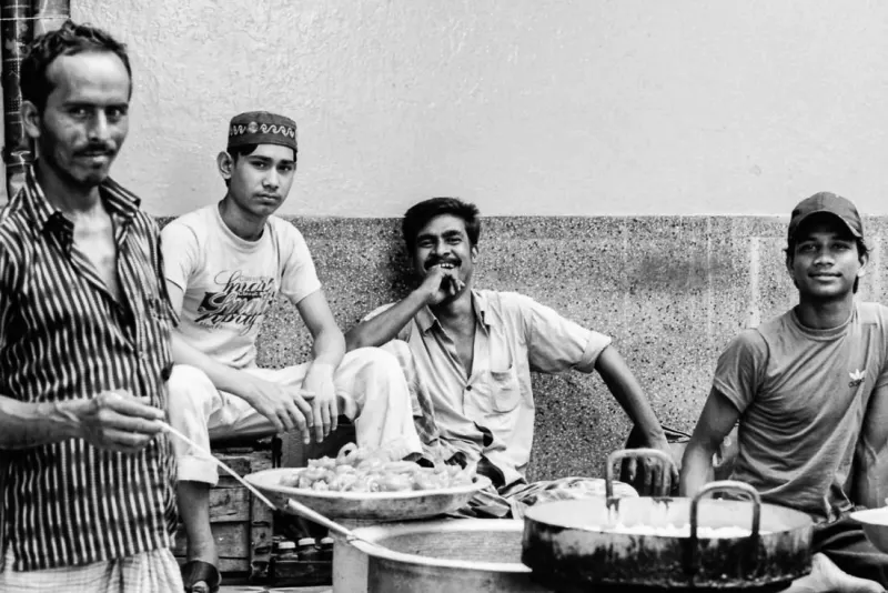 Four men around pans