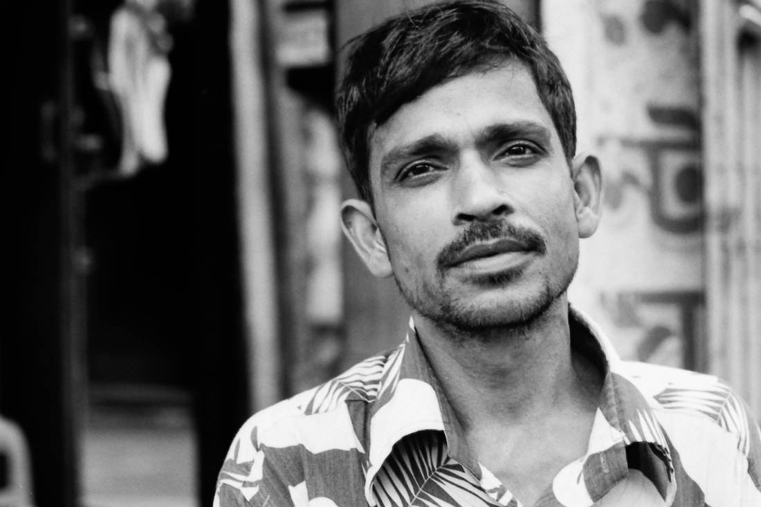 Man wearing mustache and open-necked shirt