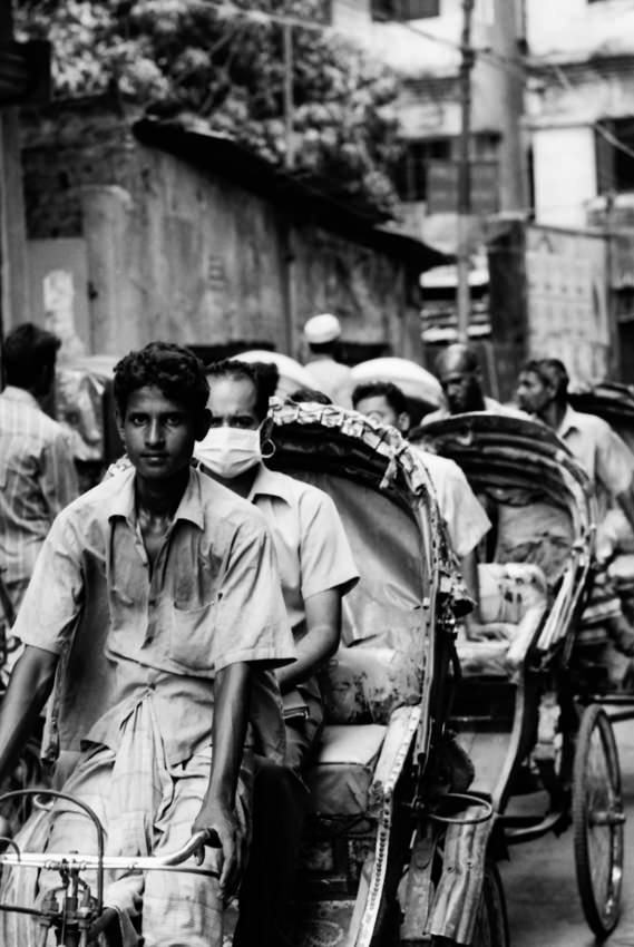 Many cycle rickshaws running street