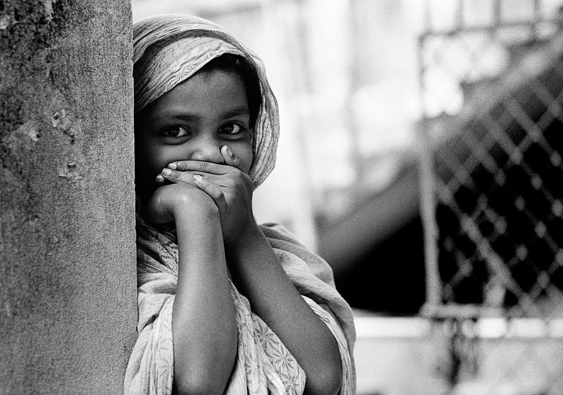 Girl looking while hiding mouth