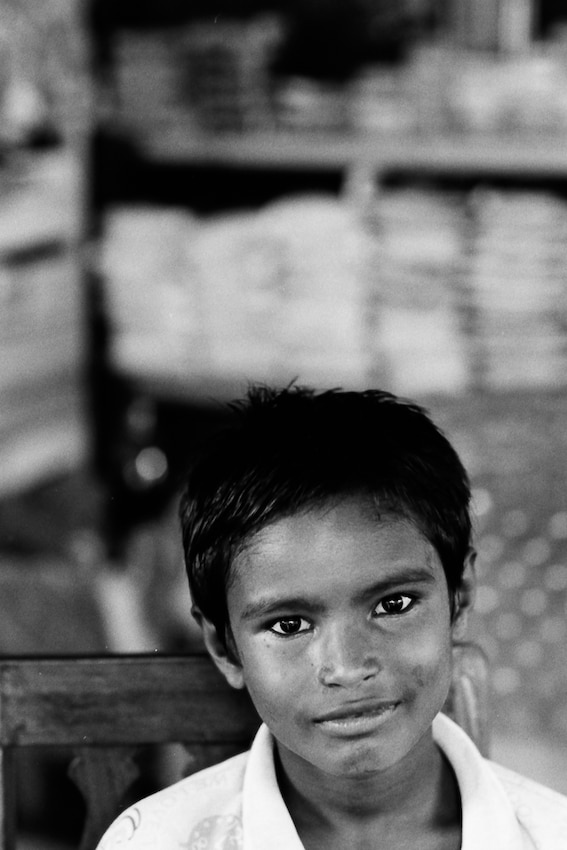 Boy guarding the store with a calm face