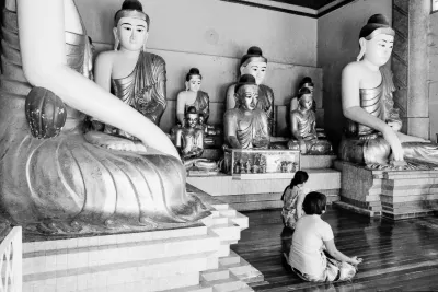 Women surrounded by Buddha statues