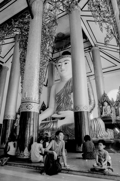 Father and son in front of Buddha statue