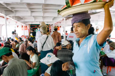 Woman selling watermelons on ferry