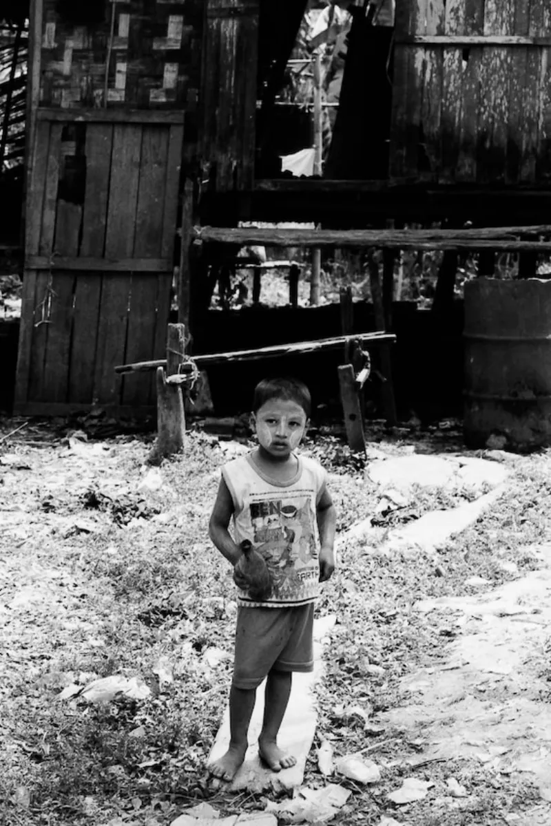 Boy standing in front of house