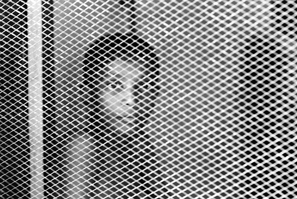 Boy In The Other Side Of A Screen Window (India)