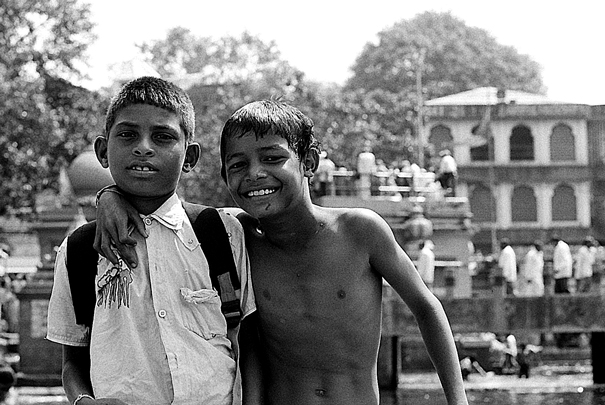 Boy Wearing A Clothes And Boy Stripping To The Wasit (India)