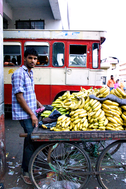 Man Selling Bananas In The Bus Terminal (India)