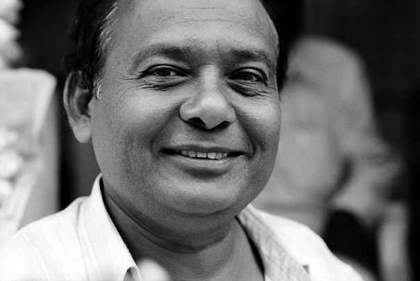 Smiling Man At A Storefront (India)