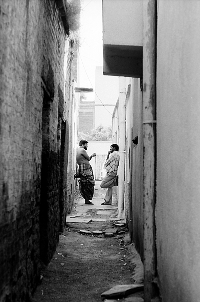 Two Men Discussing In The Back Street (India)