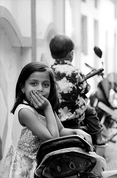 Girl putting elbow on motorbike