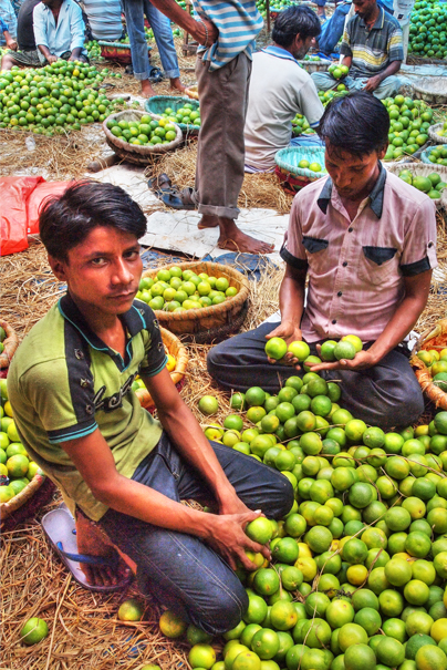 Man Beside A Heap Of Orange (India)