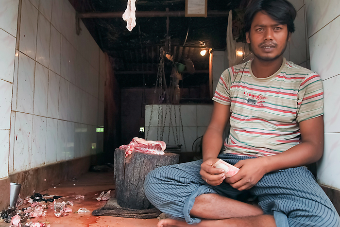 Butcher holding bills