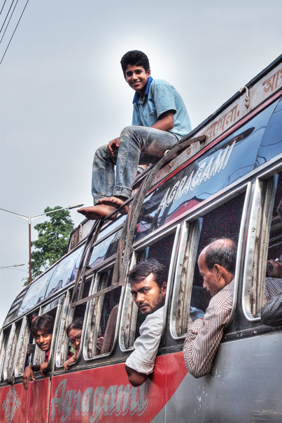Young Man On The Roof Of A Bus (India)