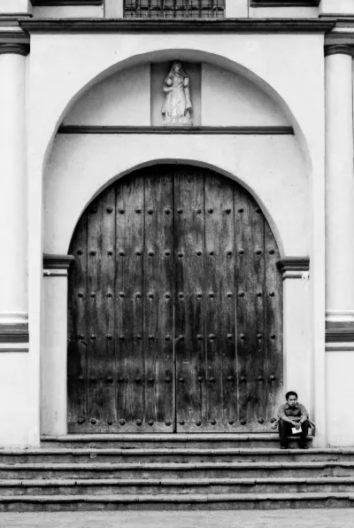 Man sitting in front of closed door