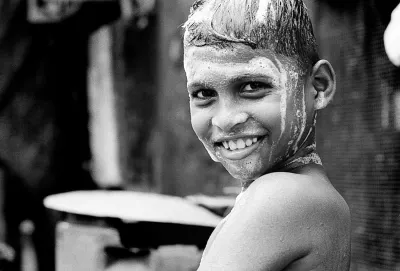 Boy shampooing by the roadside